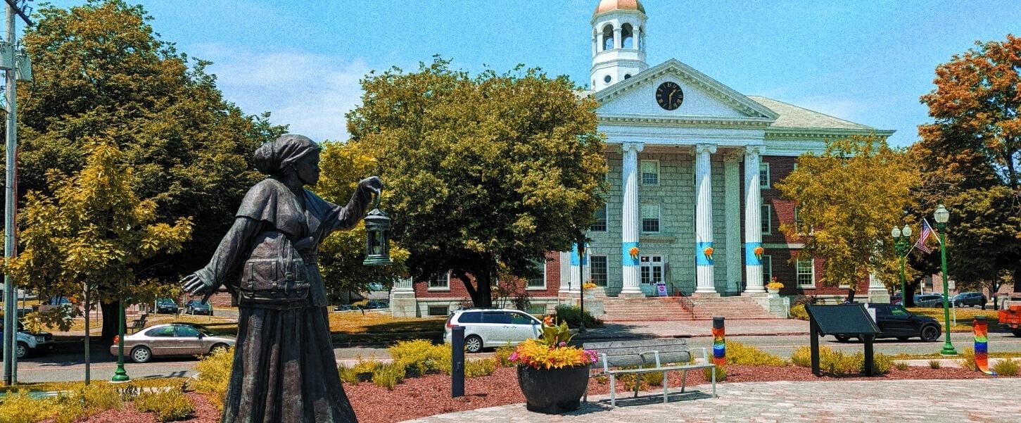 A bronze statue of Harriet Tubman stands outside the NYS Equal Rights Heritage Center.